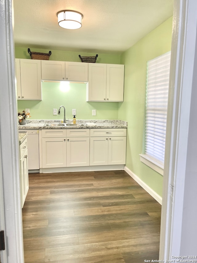 kitchen featuring white cabinets and hardwood / wood-style floors