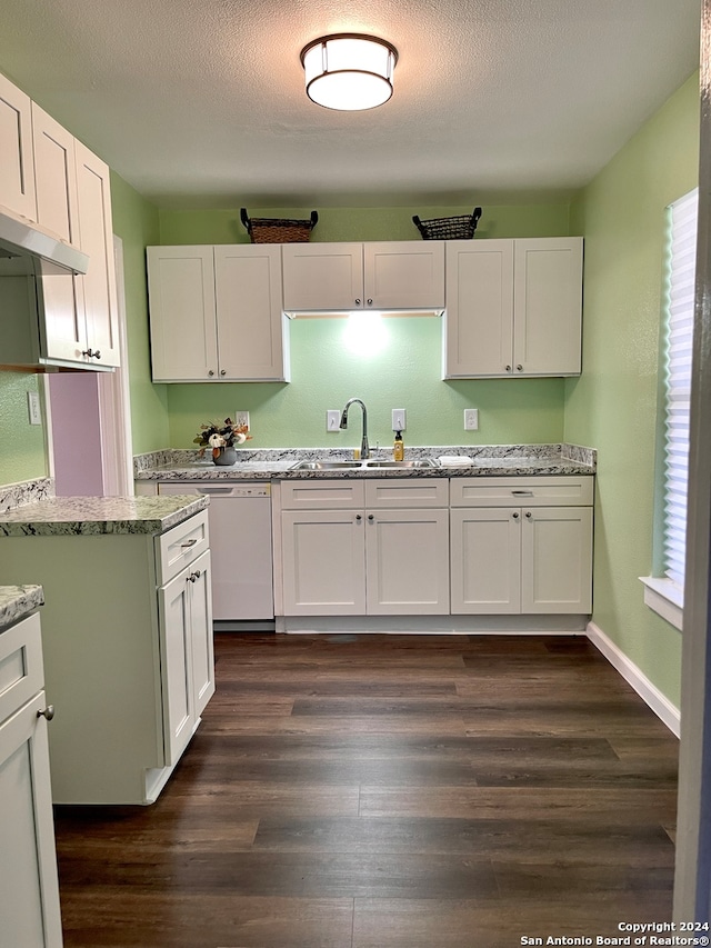 kitchen featuring white cabinets, dark hardwood / wood-style flooring, sink, and a textured ceiling