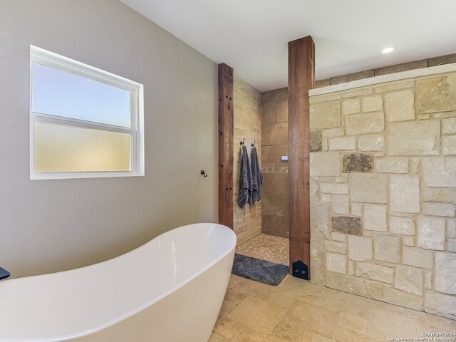 bathroom featuring independent shower and bath