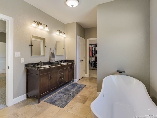 bathroom with vanity and a washtub