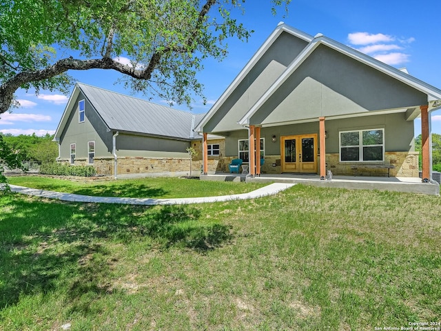 rear view of property featuring french doors and a yard