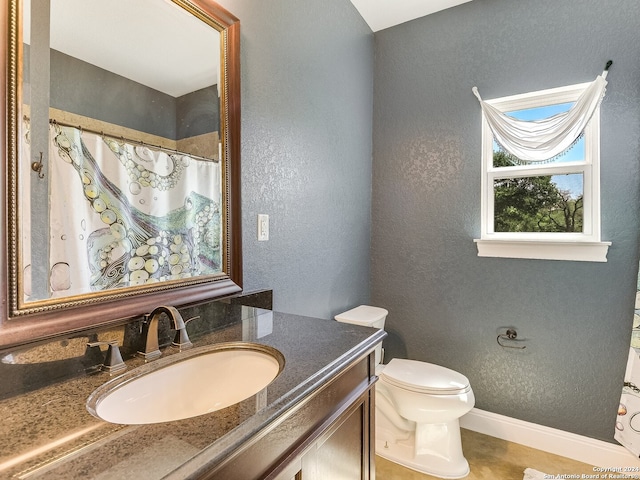 bathroom with toilet and vanity