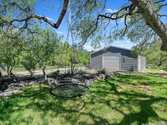 view of yard featuring an outbuilding and a garage