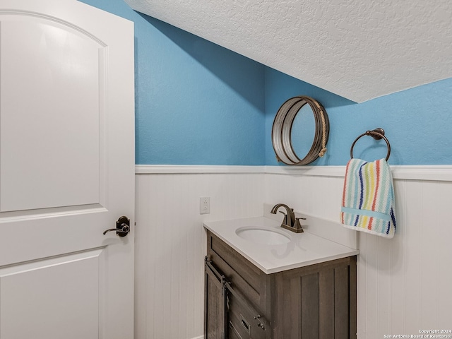 bathroom featuring vanity and a textured ceiling