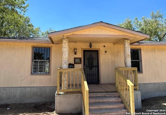 doorway to property featuring a porch