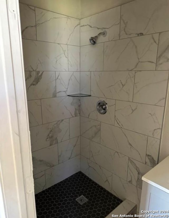 bathroom with tiled shower