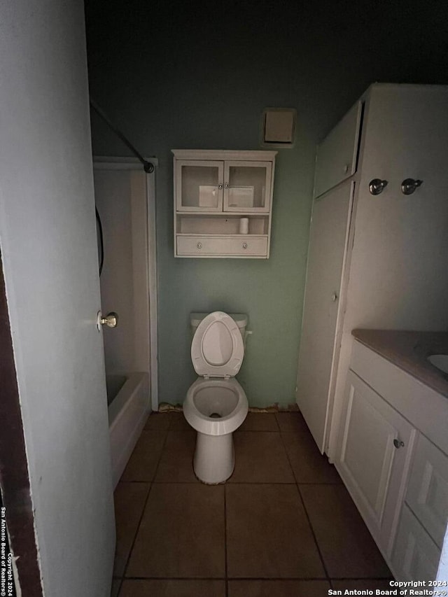 bathroom with tile patterned flooring, vanity, and toilet