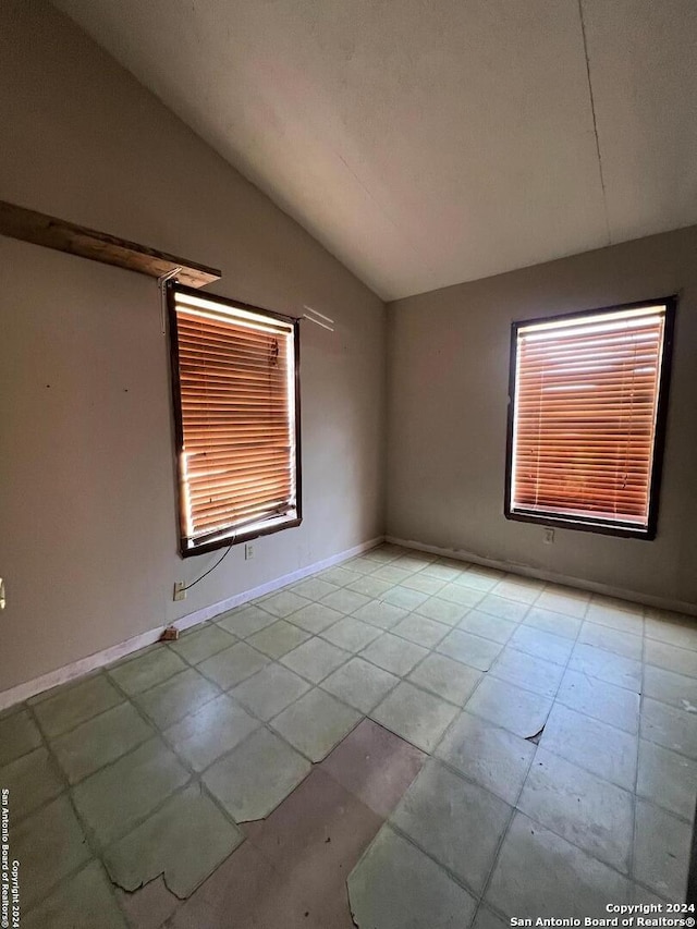 empty room with lofted ceiling