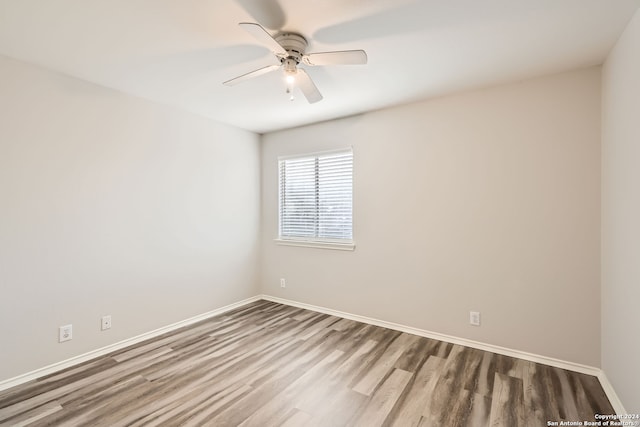 spare room with hardwood / wood-style floors and ceiling fan