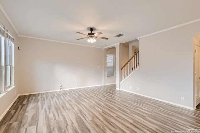 spare room with plenty of natural light, ceiling fan, crown molding, and light hardwood / wood-style flooring