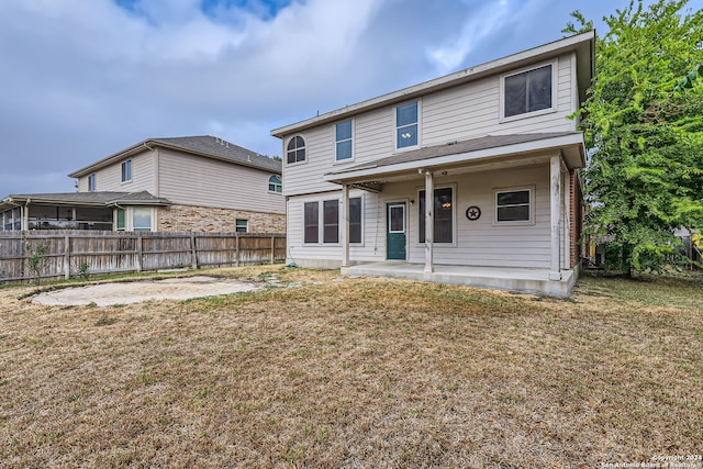 view of front of house featuring a front yard and a patio