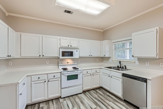 kitchen with white cabinets, sink, white appliances, and crown molding