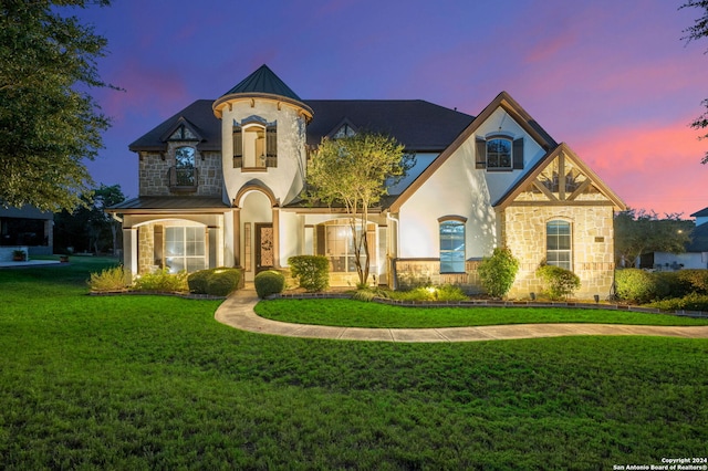 view of front of home with a lawn