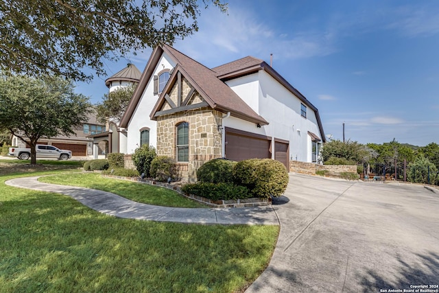 25706 Clyde Rock, Boerne, TX 78006 - view of home's exterior with stone siding, concrete driveway, a yard, and stucco siding