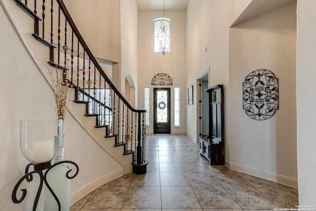 tiled foyer with a high ceiling