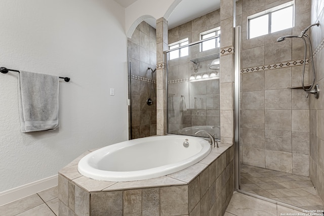 bathroom with tile patterned flooring and separate shower and tub