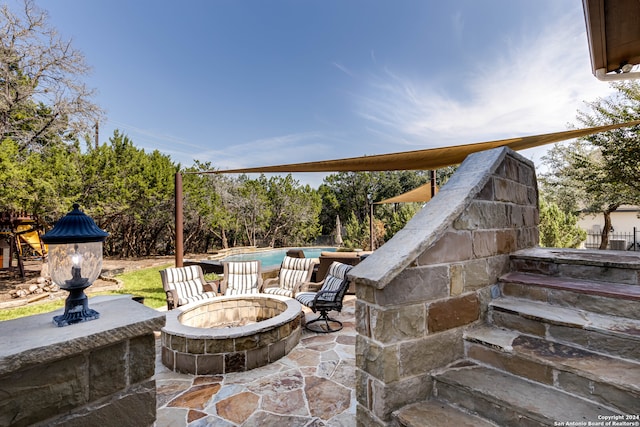 view of patio with a fire pit