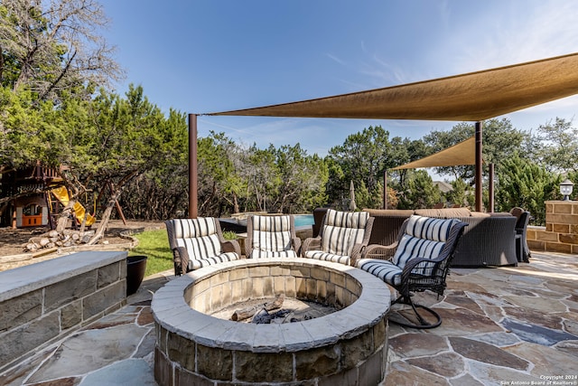 view of patio featuring a playground and a fire pit