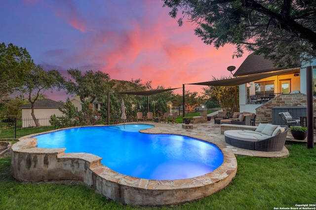 pool at dusk with a yard and a patio area