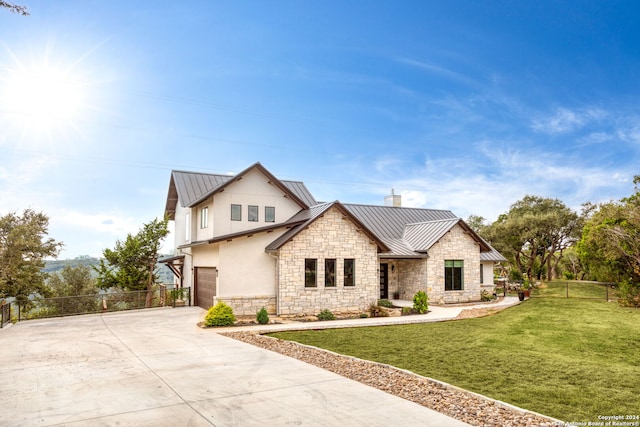 view of front of house with a garage and a front yard