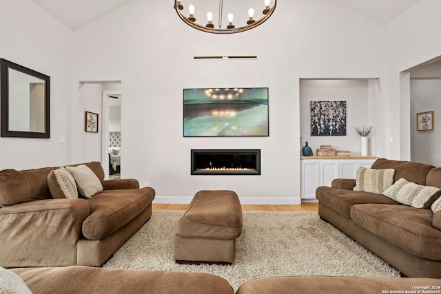 living room with high vaulted ceiling and light hardwood / wood-style floors