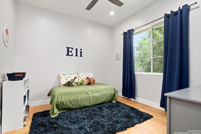 bedroom with hardwood / wood-style floors and ceiling fan