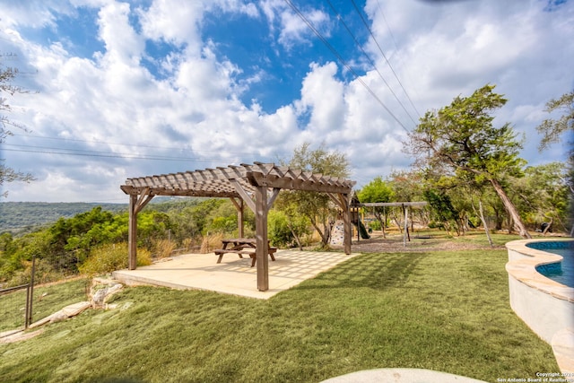 view of property's community with a pergola, a yard, and a patio area