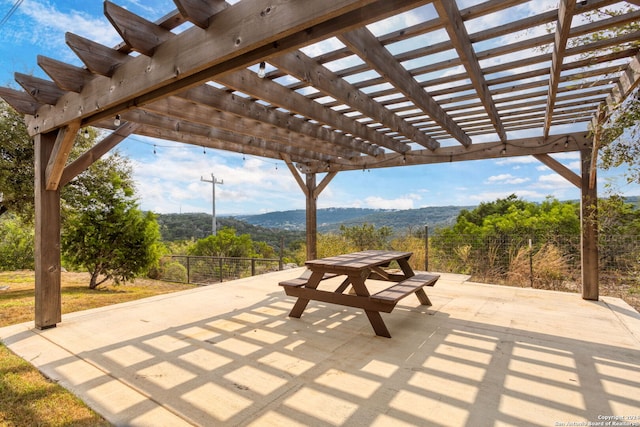 view of patio / terrace featuring a mountain view and a pergola