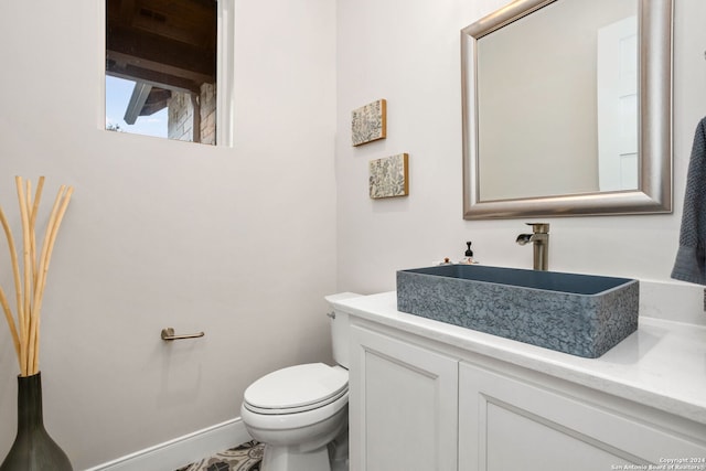 bathroom with toilet and vanity