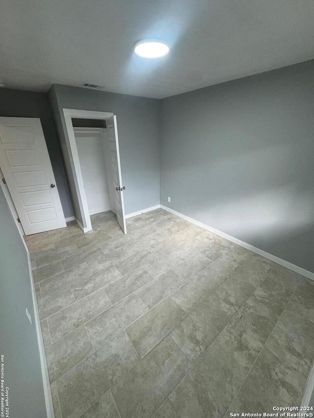 unfurnished bedroom with a closet