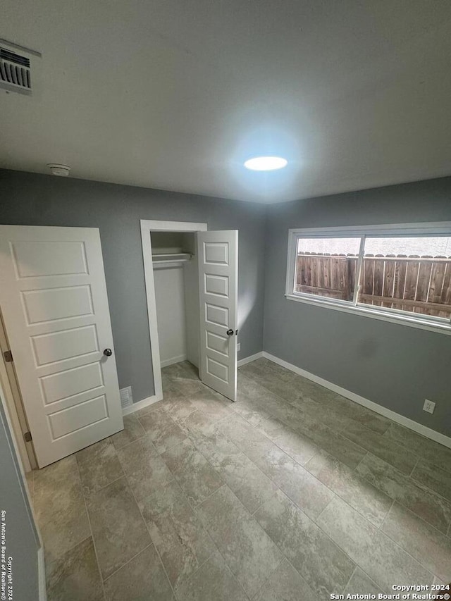 unfurnished bedroom with a closet