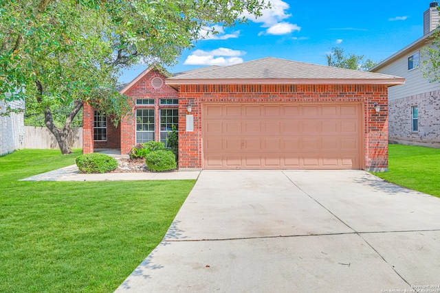 view of front of home featuring a garage and a front yard