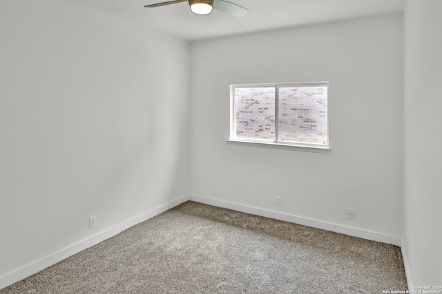 spare room featuring ceiling fan and carpet