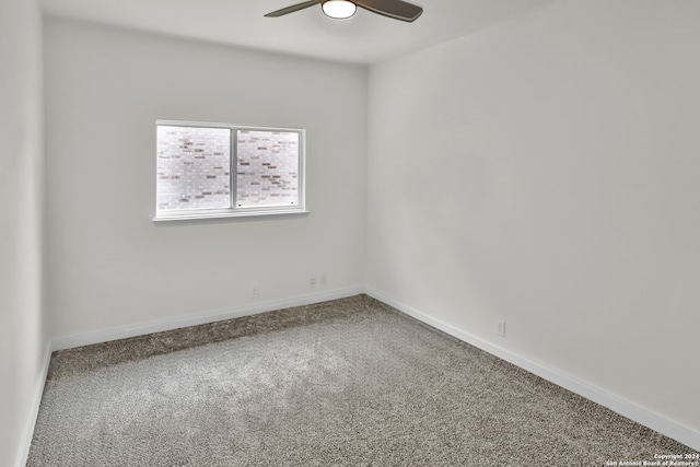 spare room featuring carpet flooring and ceiling fan