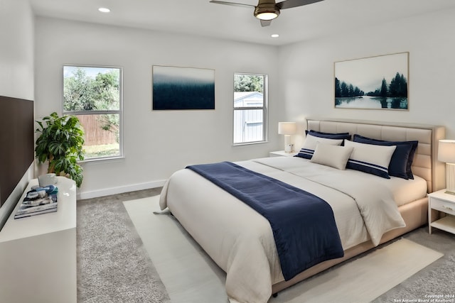 bedroom with ceiling fan and light carpet