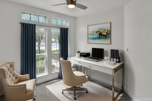 office featuring ceiling fan, a wealth of natural light, and light colored carpet