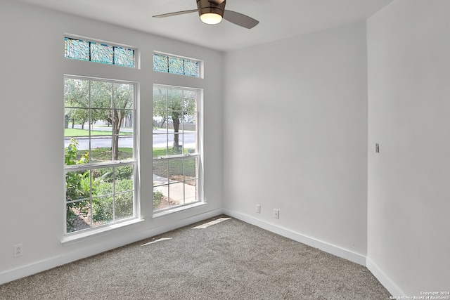 spare room featuring ceiling fan, plenty of natural light, and carpet floors