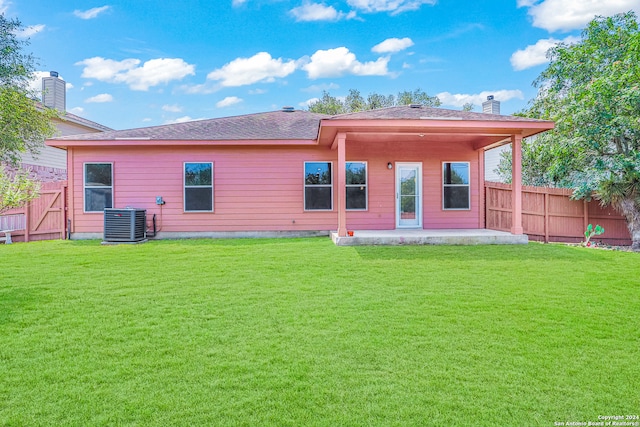 rear view of house featuring central AC, a yard, and a patio area