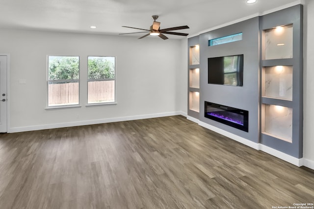 unfurnished living room featuring ceiling fan and dark hardwood / wood-style floors