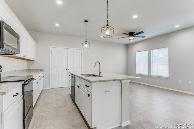 kitchen featuring black appliances, a center island with sink, decorative light fixtures, sink, and white cabinets