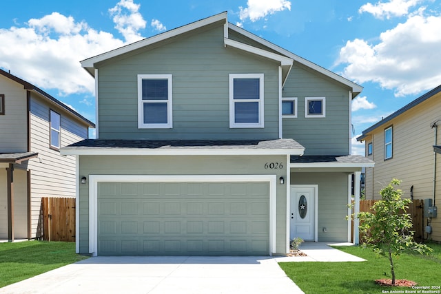 front of property with a garage and a front lawn