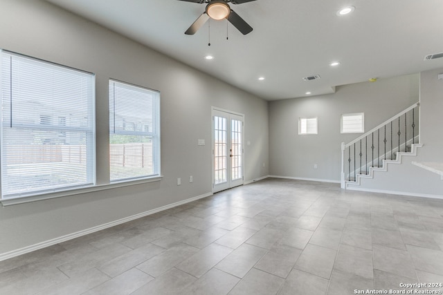 tiled empty room with french doors and ceiling fan