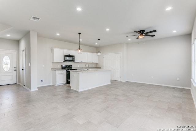 kitchen featuring black appliances, white cabinetry, decorative light fixtures, sink, and a kitchen island with sink