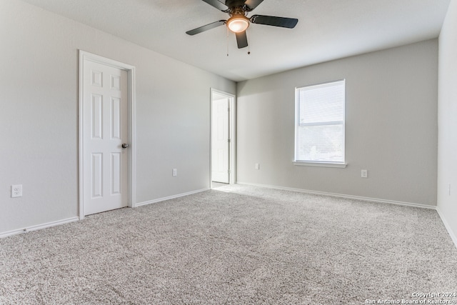 carpeted spare room with ceiling fan