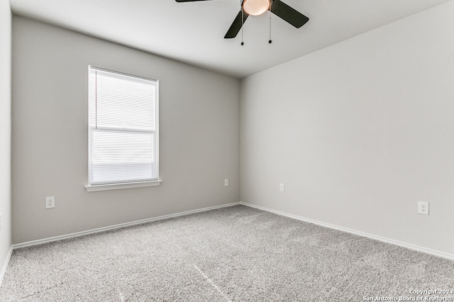 carpeted spare room with ceiling fan and a healthy amount of sunlight