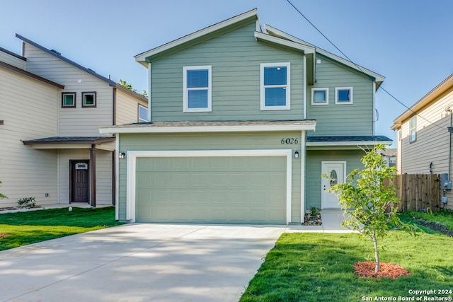 front facade with a garage and a front yard