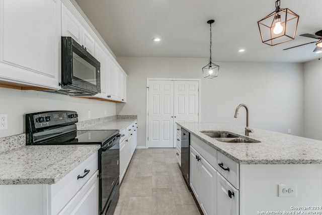 kitchen featuring a center island with sink, white cabinets, black appliances, sink, and pendant lighting