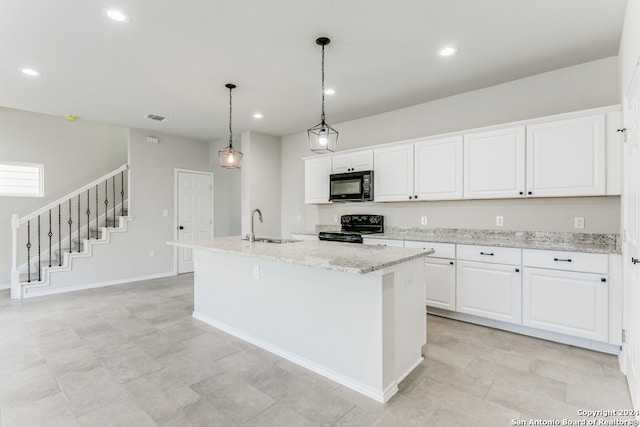 kitchen with white cabinetry, black appliances, light stone countertops, a kitchen island with sink, and pendant lighting