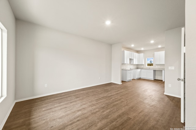 unfurnished living room featuring dark wood-type flooring