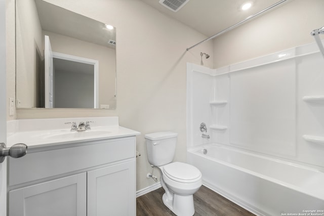 full bathroom with toilet, washtub / shower combination, vanity, and hardwood / wood-style floors